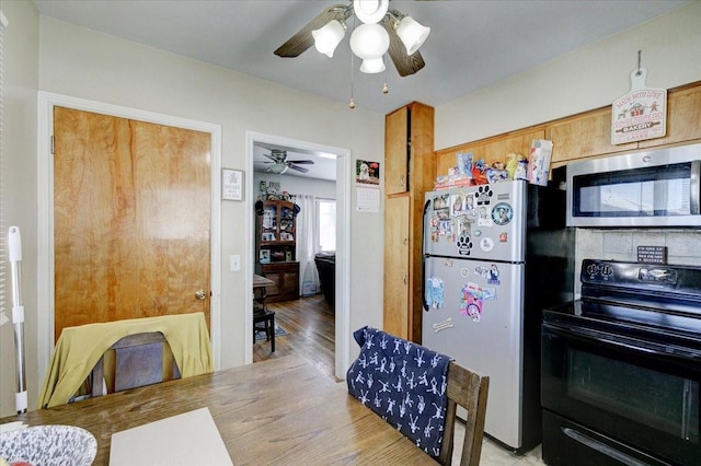 kitchen with stainless steel appliances and a ceiling fan