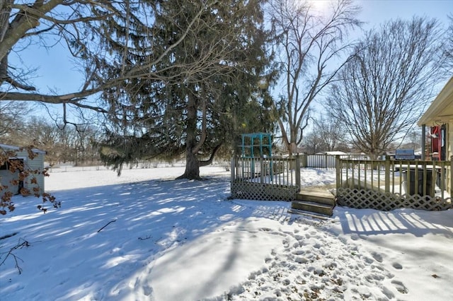 yard layered in snow with a deck