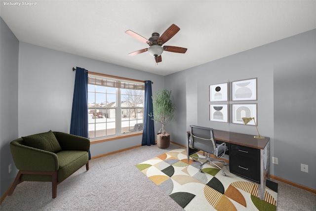 office area with ceiling fan, baseboards, and light colored carpet