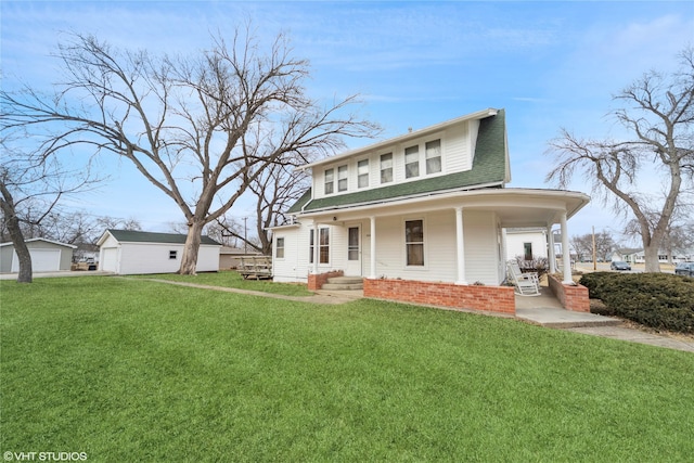 view of front of home with brick siding, a detached garage, a porch, a shingled roof, and a front yard