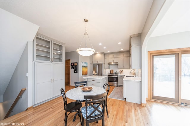 dining space with light wood-style floors and recessed lighting