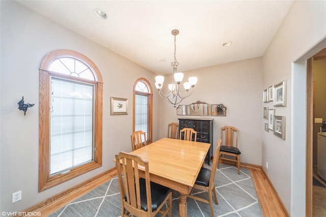 dining room with light wood-style floors, recessed lighting, a chandelier, and baseboards