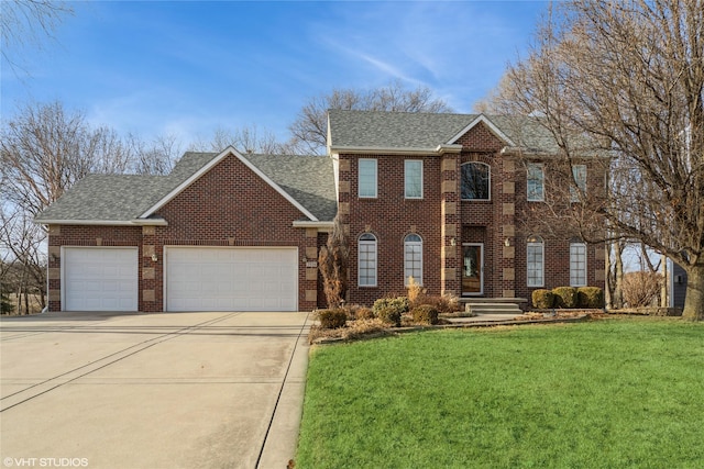 colonial house with brick siding, a shingled roof, a front yard, a garage, and driveway