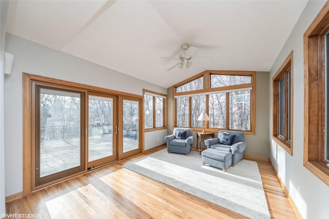 sunroom / solarium featuring lofted ceiling, a ceiling fan, and a wealth of natural light