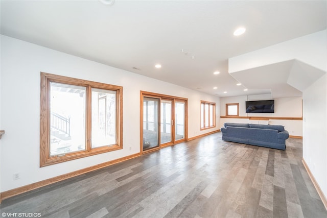 unfurnished living room featuring baseboards, wood finished floors, and recessed lighting