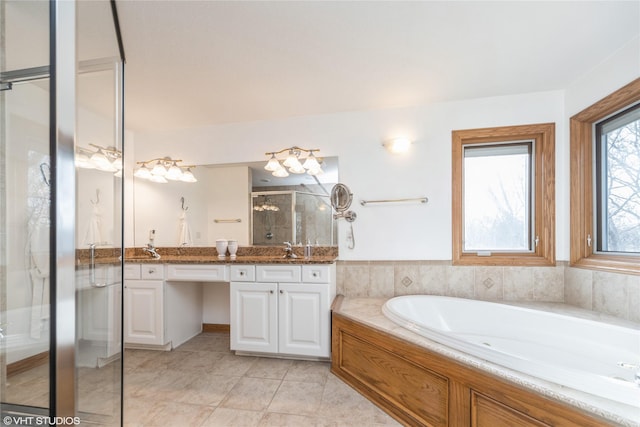 bathroom featuring double vanity, a bath, tile patterned flooring, a shower stall, and a sink