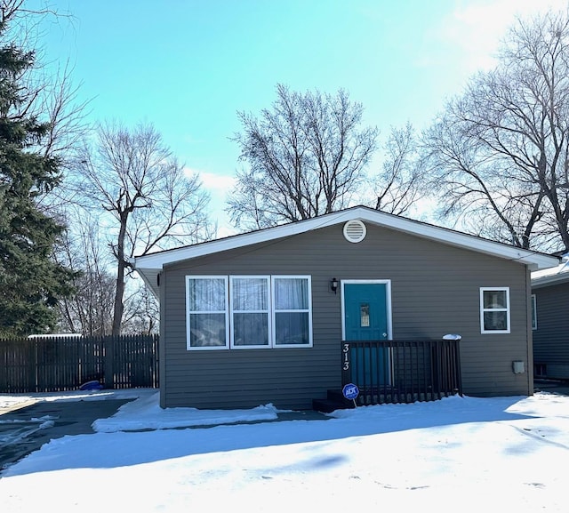 view of front of home featuring fence