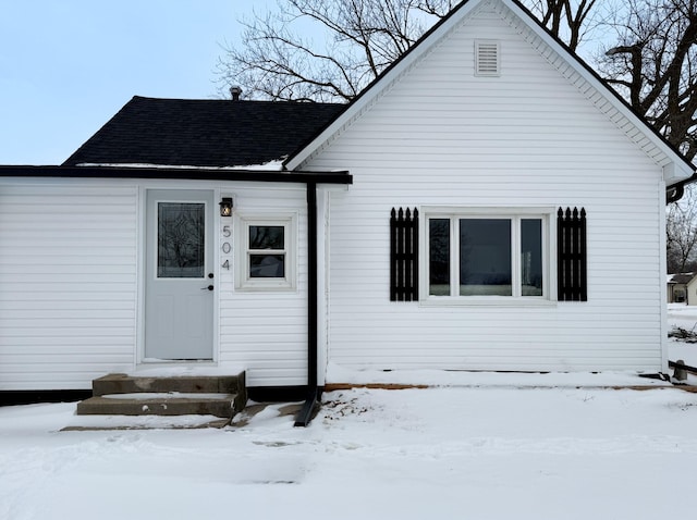 view of front of house with entry steps and roof with shingles