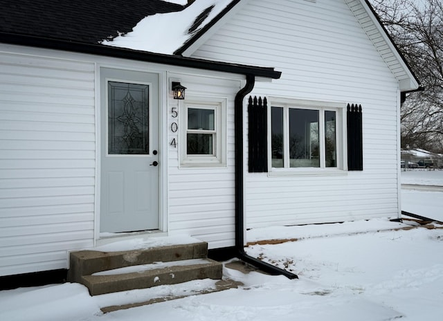 view of snow covered property entrance