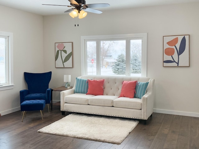 living room with baseboards, dark wood-style flooring, and a healthy amount of sunlight