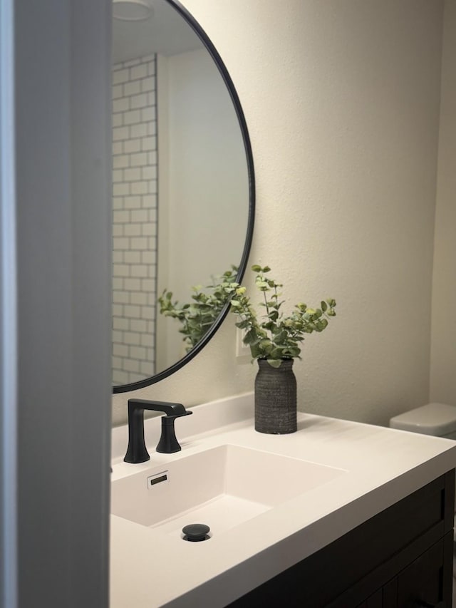 bathroom with toilet and vanity