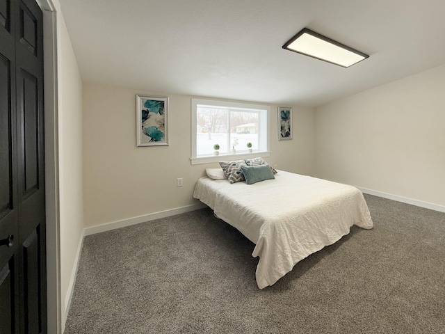 carpeted bedroom featuring baseboards