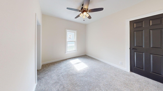 unfurnished bedroom featuring light carpet, ceiling fan, and baseboards