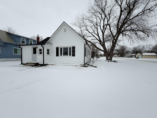 view of snow covered back of property