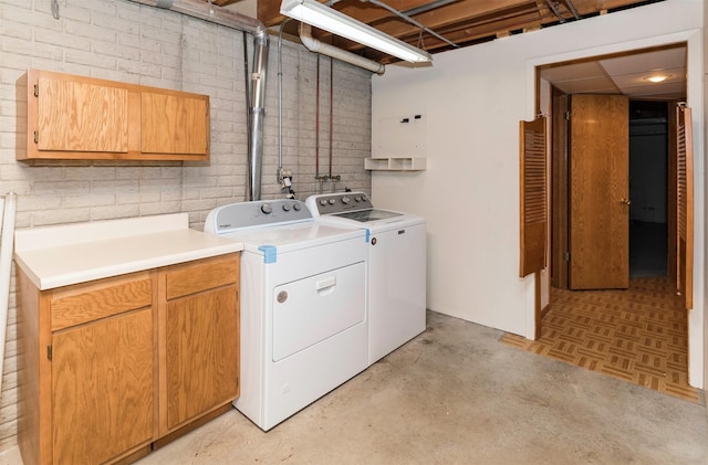 laundry area featuring cabinet space and separate washer and dryer