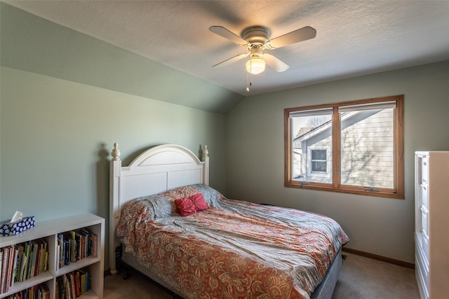 bedroom featuring lofted ceiling, a textured ceiling, a ceiling fan, baseboards, and carpet