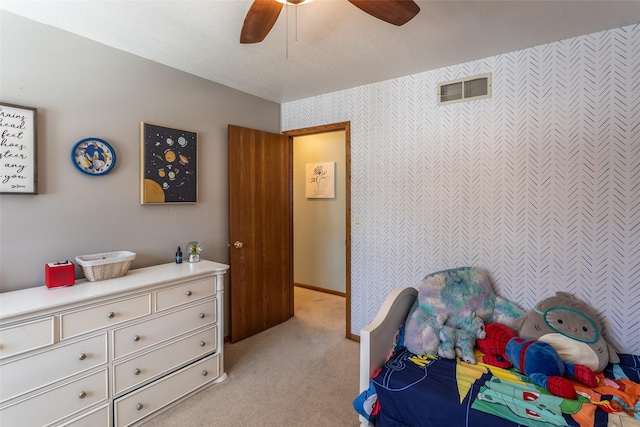 bedroom featuring a ceiling fan, light carpet, and visible vents