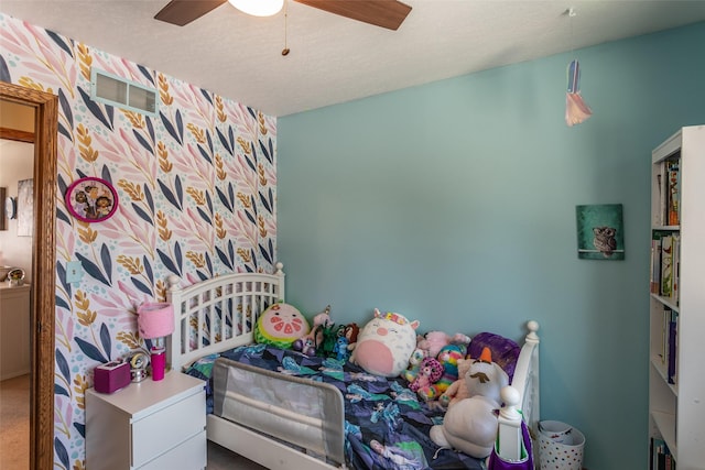 bedroom featuring ceiling fan, a textured ceiling, carpet, and visible vents