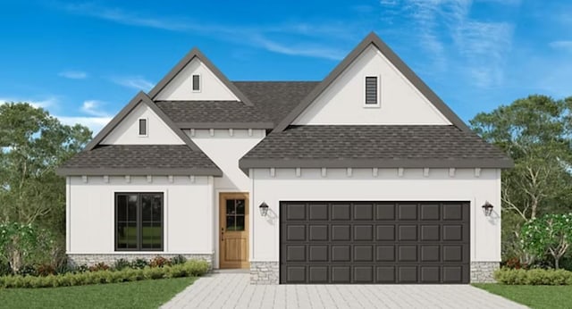 view of front of property featuring a garage, stone siding, a shingled roof, and decorative driveway