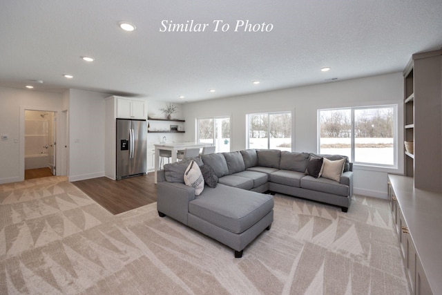 2646 SE Steele Dr, Waukee, IA 50263 - living area featuring light colored carpet, recessed lighting, and baseboards