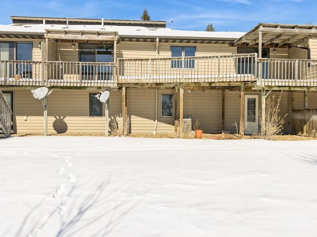 view of snow covered rear of property