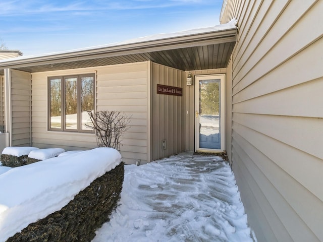 view of snow covered property entrance