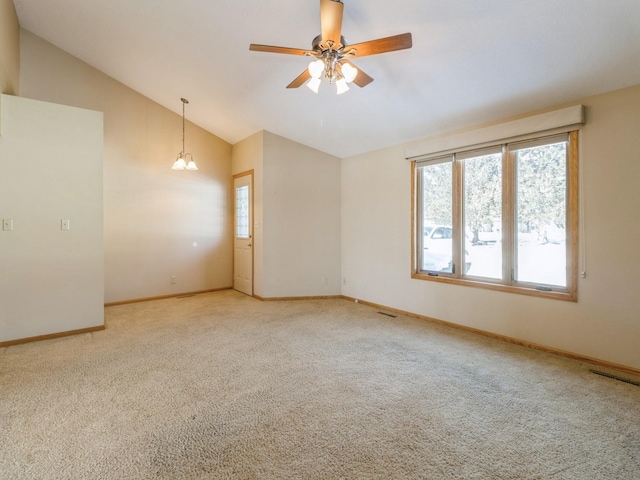 empty room featuring a ceiling fan, light colored carpet, and baseboards