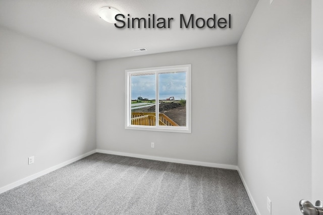 carpeted spare room with baseboards and visible vents