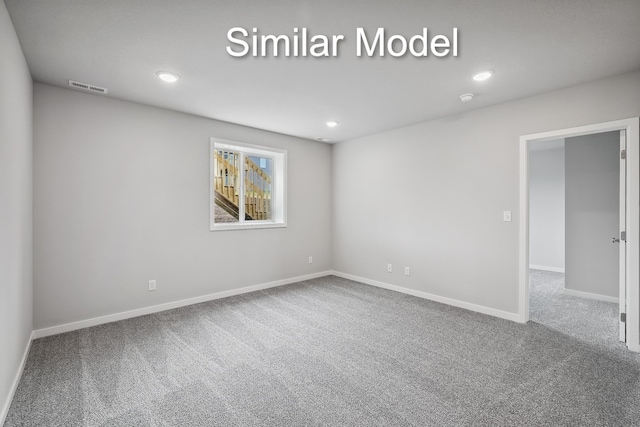 carpeted spare room featuring recessed lighting, visible vents, and baseboards