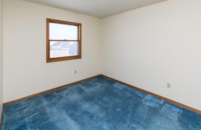 carpeted empty room featuring visible vents and baseboards