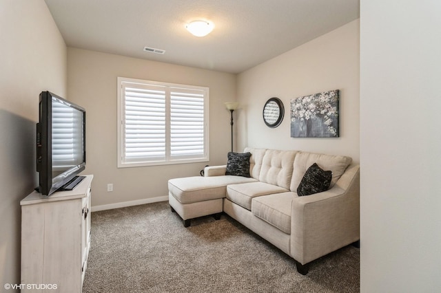 living room with carpet floors, visible vents, and baseboards