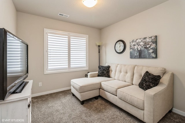 living area featuring carpet floors, baseboards, and visible vents