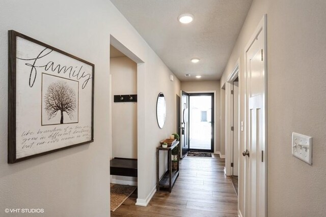 805 Cherry St NW, Bondurant, IA 50035 - hallway with baseboards, wood finished floors, and recessed lighting