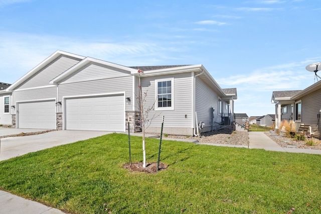 ranch-style home featuring driveway, an attached garage, and a front yard