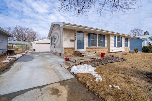 view of front facade featuring a garage, an outbuilding, brick siding, and entry steps