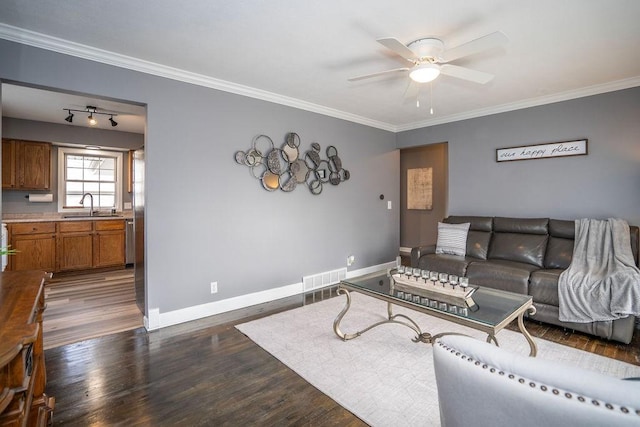 living area featuring crown molding, visible vents, dark wood finished floors, and baseboards