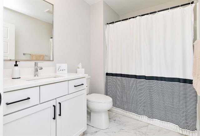 full bathroom with marble finish floor, vanity, and toilet