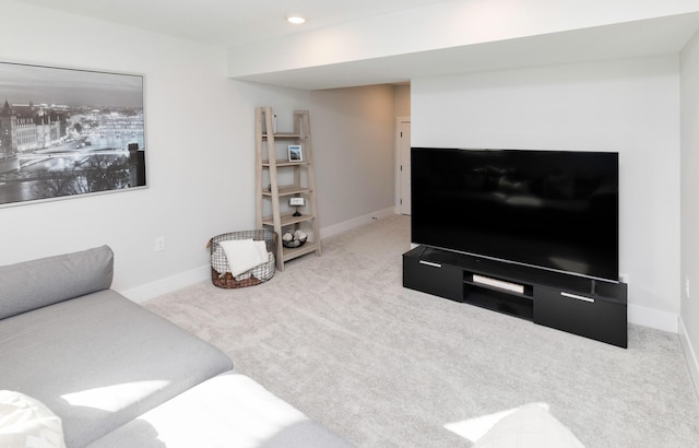 carpeted living area with recessed lighting and baseboards