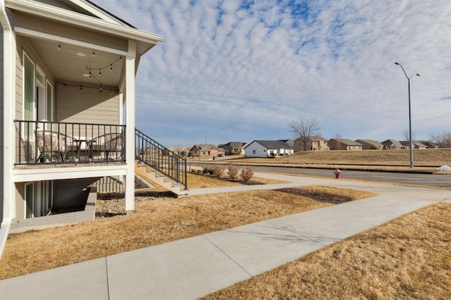 view of yard with stairs and a residential view