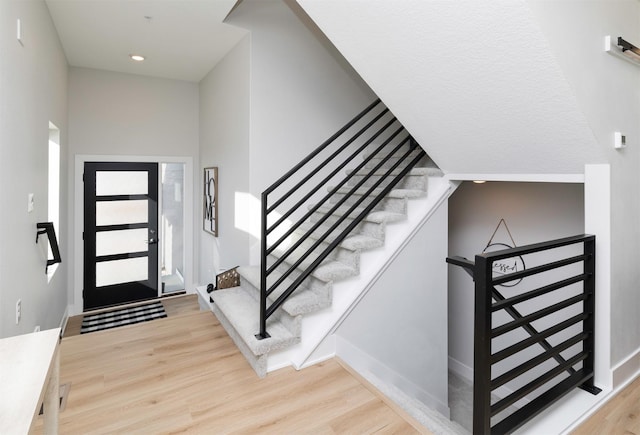 entryway with stairway, light wood-style flooring, and recessed lighting