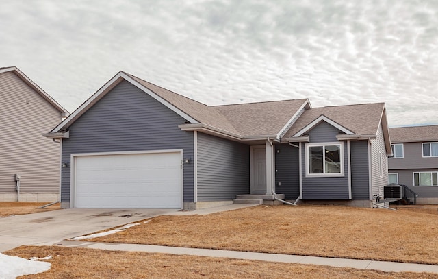 ranch-style house with a garage, roof with shingles, and driveway