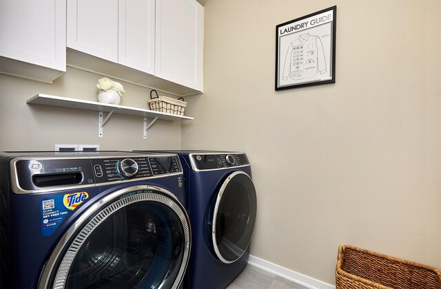 laundry room with cabinet space, baseboards, and separate washer and dryer