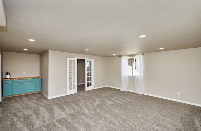 spare room featuring carpet, french doors, baseboards, and recessed lighting