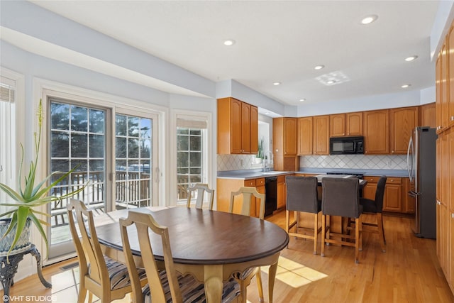 dining room featuring light wood-style flooring and recessed lighting