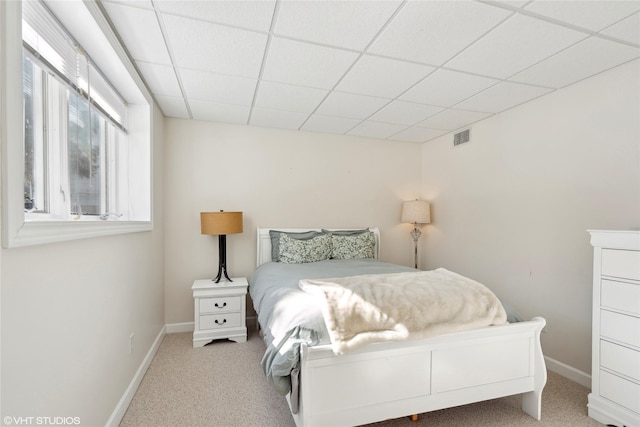 bedroom featuring carpet floors, a paneled ceiling, visible vents, and baseboards