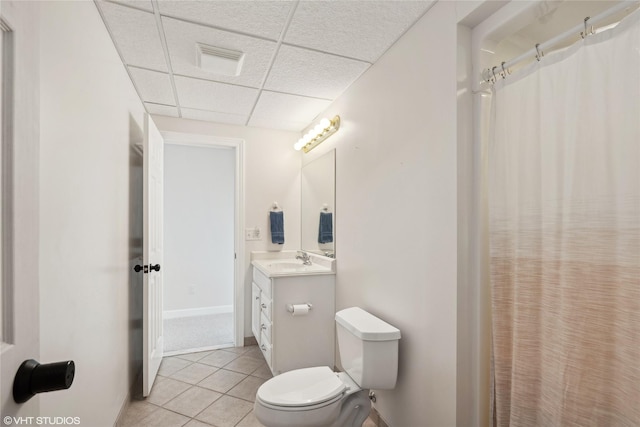 full bathroom with visible vents, a drop ceiling, toilet, tile patterned floors, and vanity