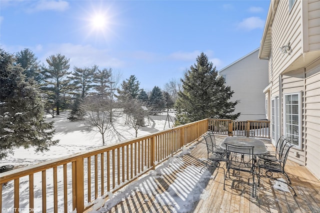 snow covered deck with outdoor dining area