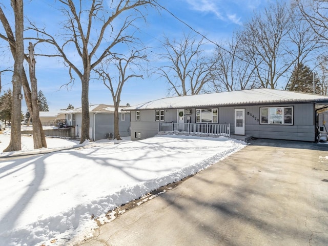 ranch-style house with driveway and covered porch