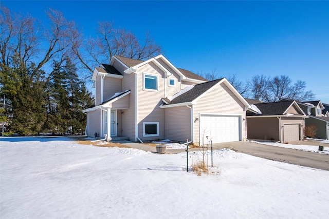 view of snow covered exterior featuring an attached garage