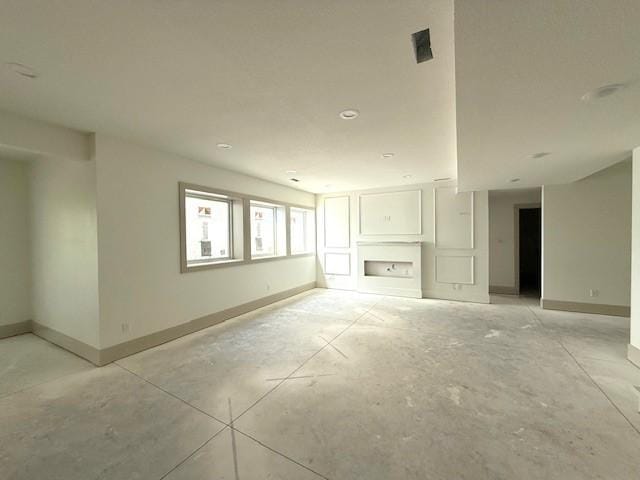 570 El Dorado Ct, Waukee, IA 50263 - empty room with baseboards and concrete flooring